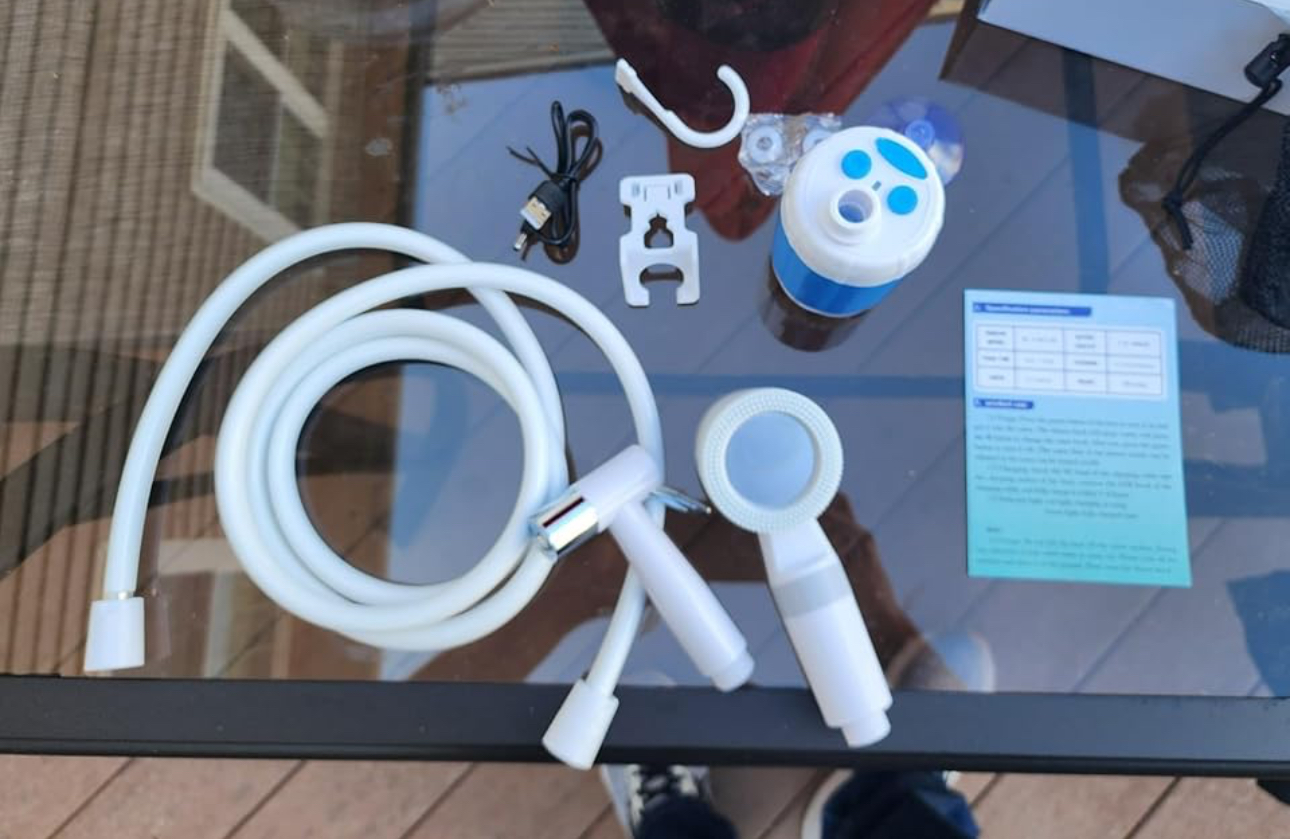 Portable shower pieces arranged on a table